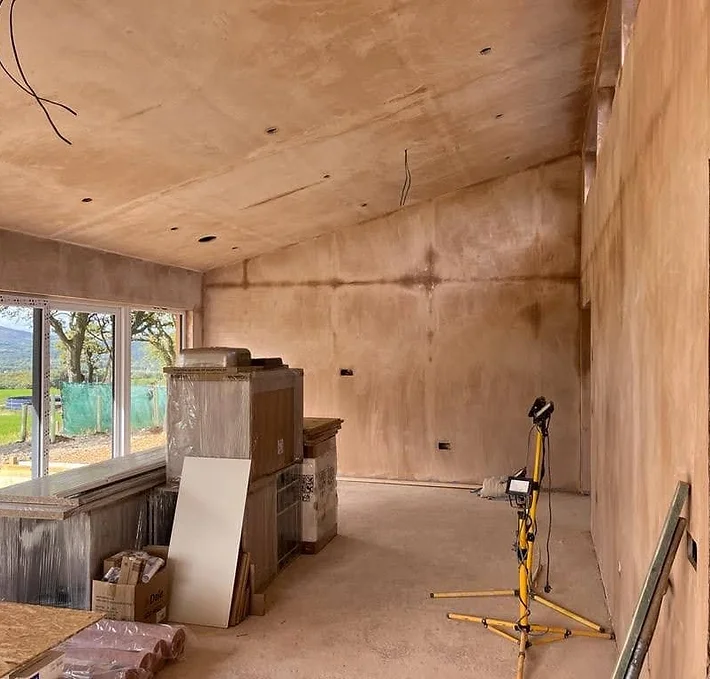 A spacious interior of the lodge in its construction phase, The walls have been plastered but , showcasing the initial stages of building this luxury lodge beauty of the Scottish nature